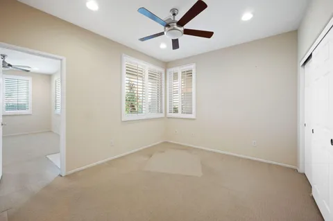 a view of a livingroom with a ceiling fan and window