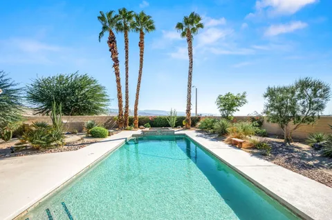 a view of a house with backyard and swimming pool