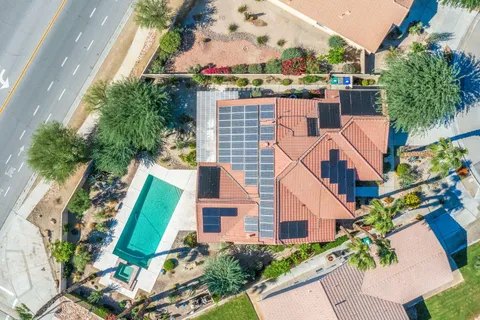 an aerial view of a house with a yard and potted plants
