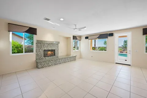 a large white kitchen with cabinets a sink a window and stainless steel appliances