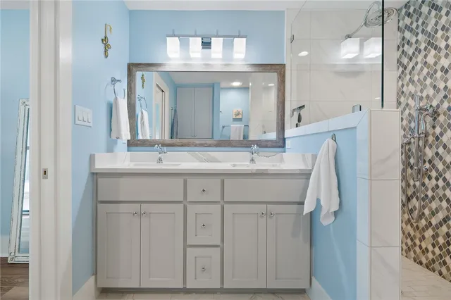 a bathroom with a sink vanity and a mirror