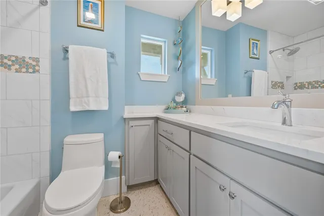 a bathroom with a sink a toilet and mirror