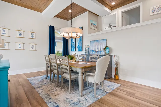 a dining room with furniture a rug and wooden floor