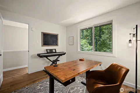a room with furniture pool table and windows