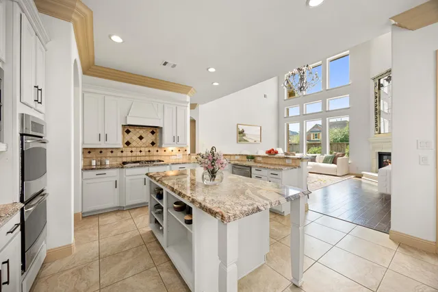 a view of a dining room with furniture and chandelier