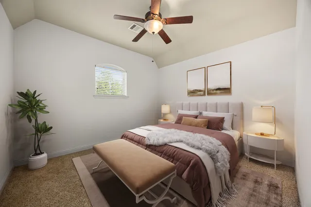 a bedroom with a large bed and a chandelier