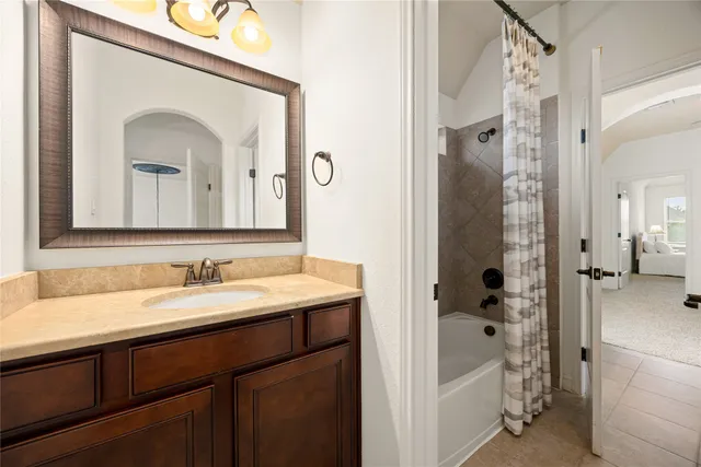 a bedroom with a bed tv and window