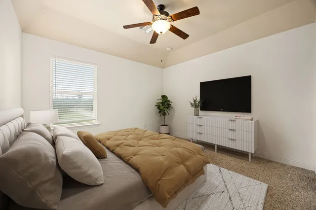 a front view of house with yard and trees in the background