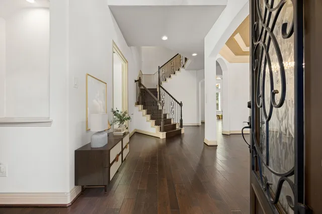 a living room with furniture a fireplace and a potted plant