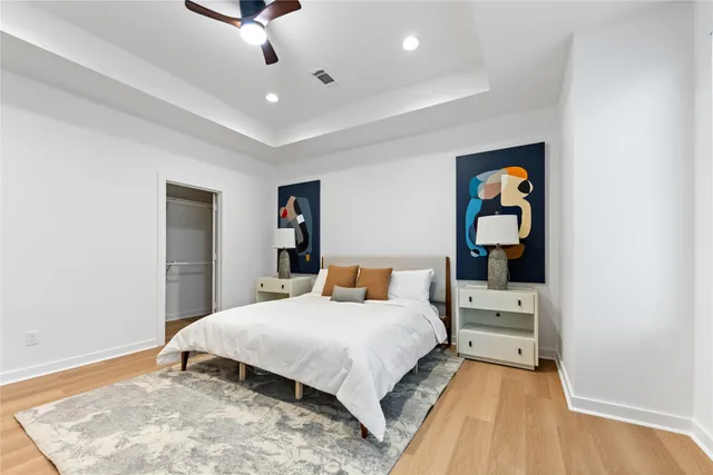 a bedroom with a bed and wooden floor