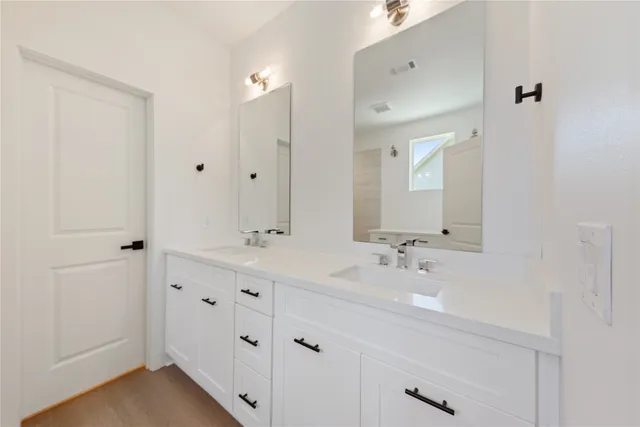 a bathroom with a shower and a sink