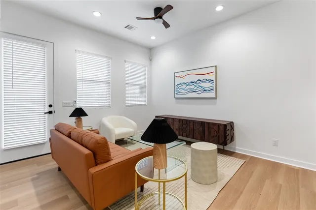 a kitchen with stainless steel appliances a table chairs and a refrigerator