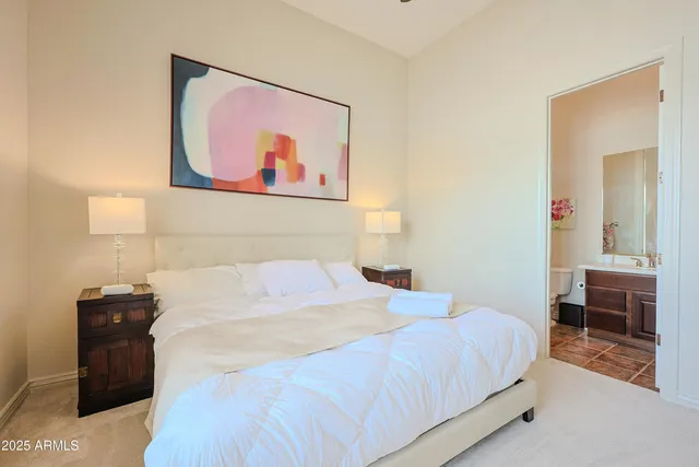 a spacious bathroom with a double vanity sink a mirror and a shower