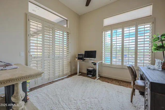 a bedroom with a bed and a painting on the wall