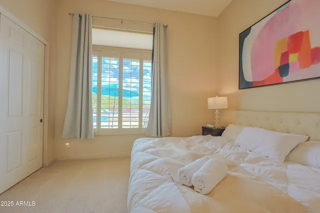 a bedroom with a bed and a desk