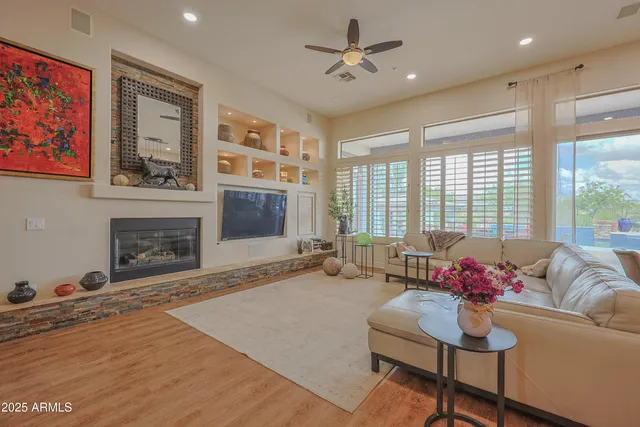 a kitchen with stainless steel appliances granite countertop a sink a stove and a wooden floors