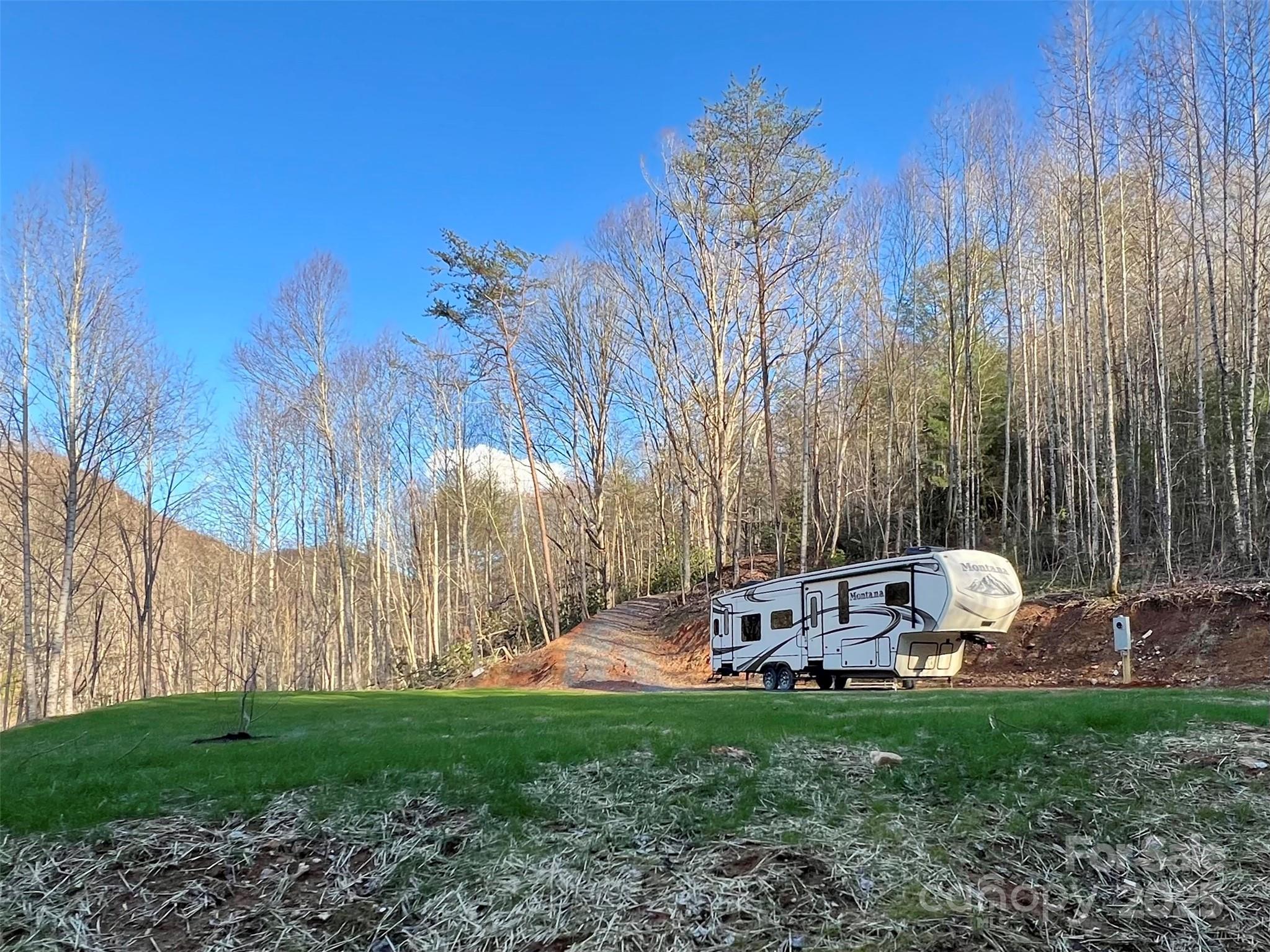 7042 Yellow Creek Road Robbinsville, NC 28771 - Photo 1 of 18 a backyard of a house with table and chairs