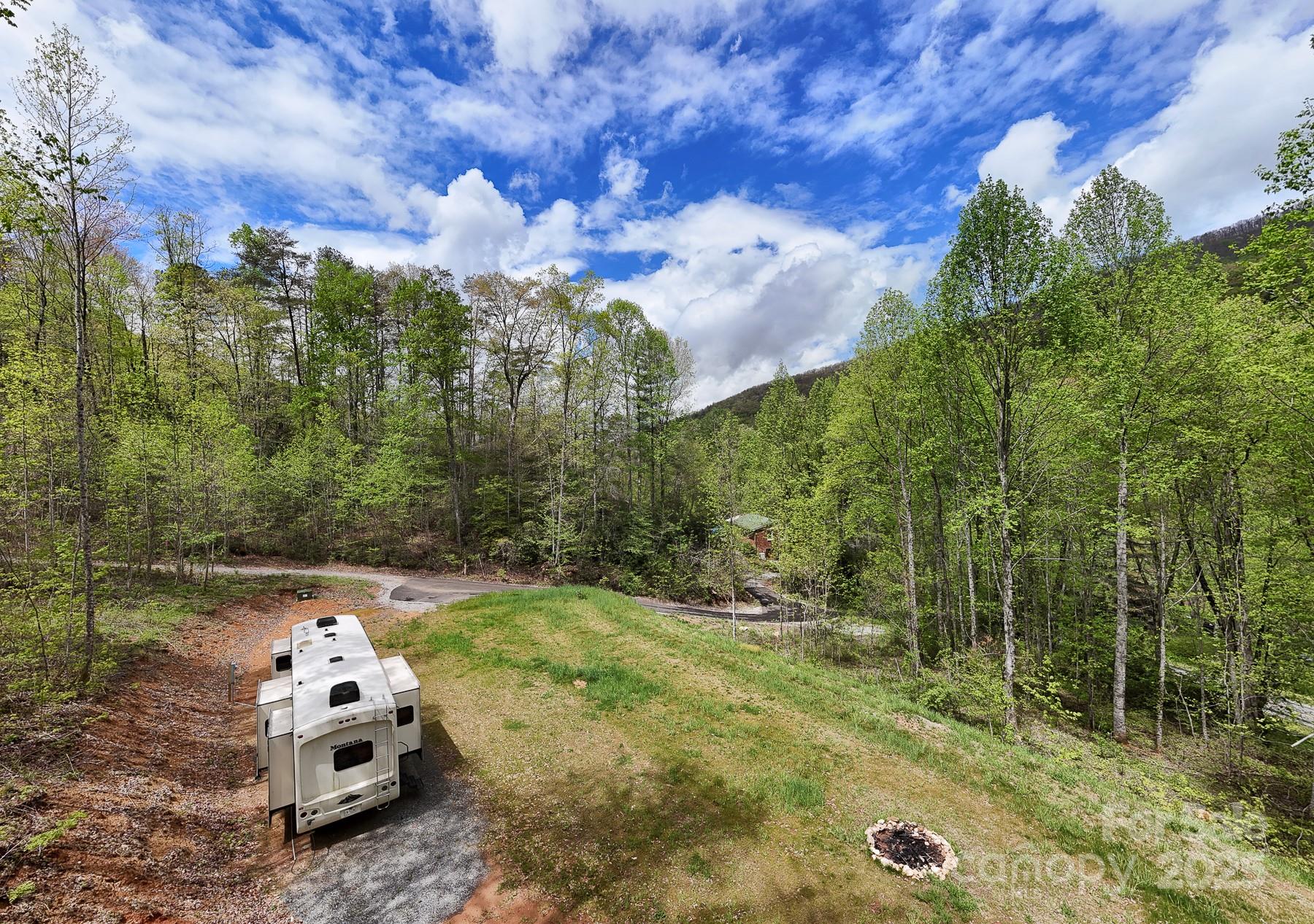 7042 Yellow Creek Road Robbinsville, NC 28771 - Photo 5 of 18 a white house covered with tall trees