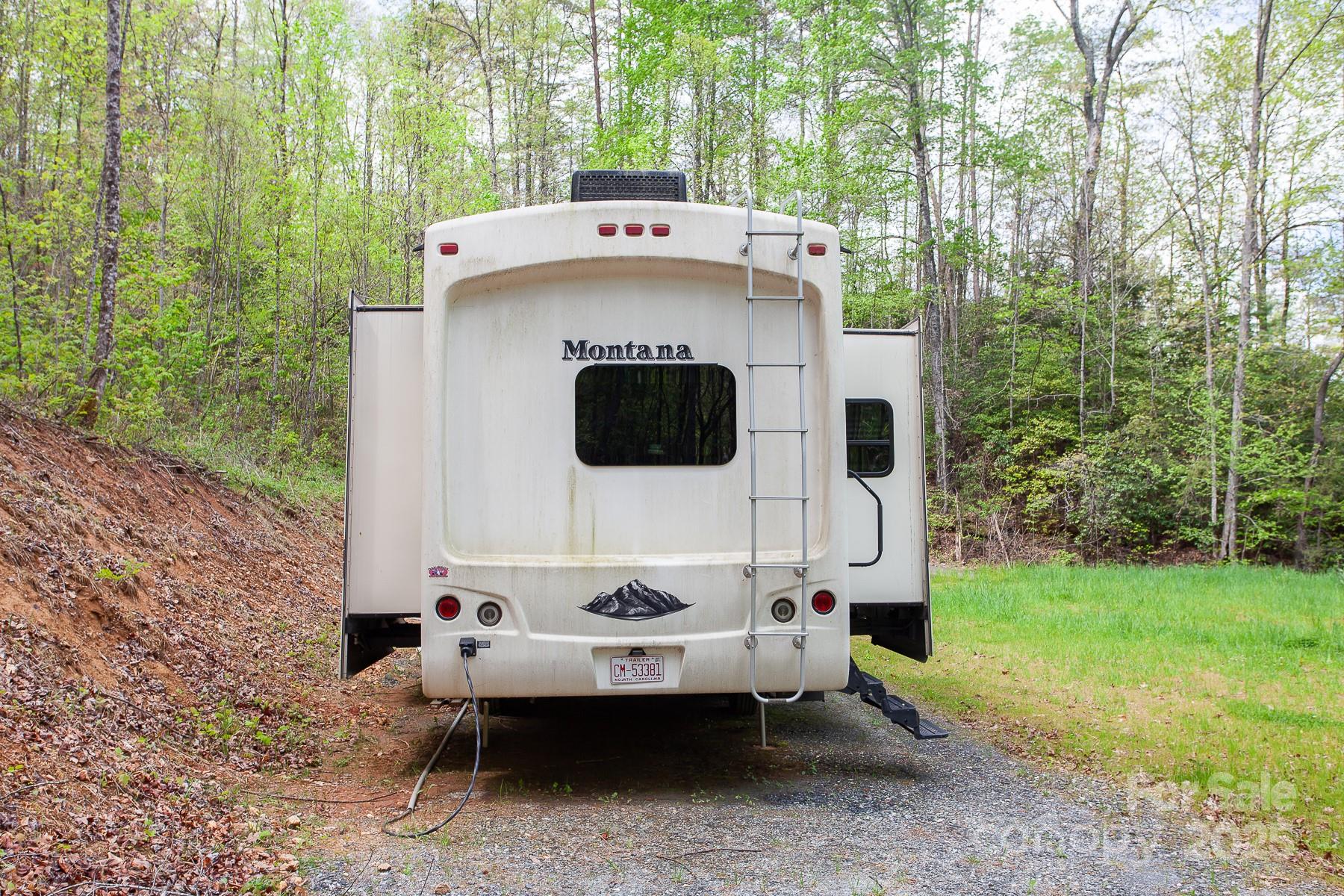 7042 Yellow Creek Road Robbinsville, NC 28771 - Photo 9 of 18 a view of a back yard with a table and chairs