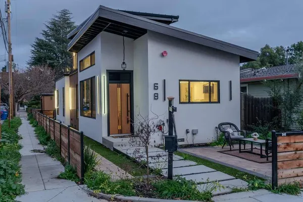 a front view of a house with garden