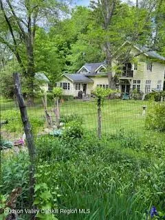 a view of a house with a yard and sitting area