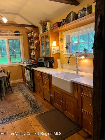 a spacious bathroom with a granite countertop sink and a mirror
