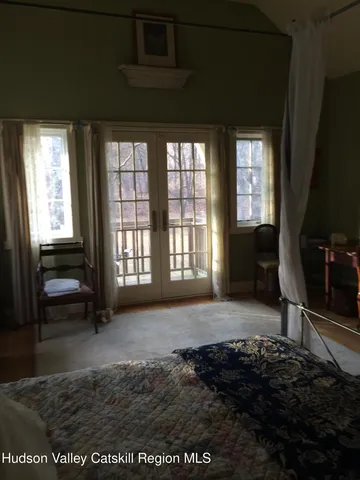 a view of a livingroom with wooden floor and a fireplace