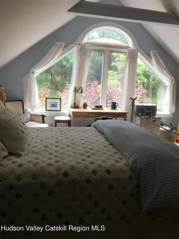 a living room with furniture large window and floor to ceiling window