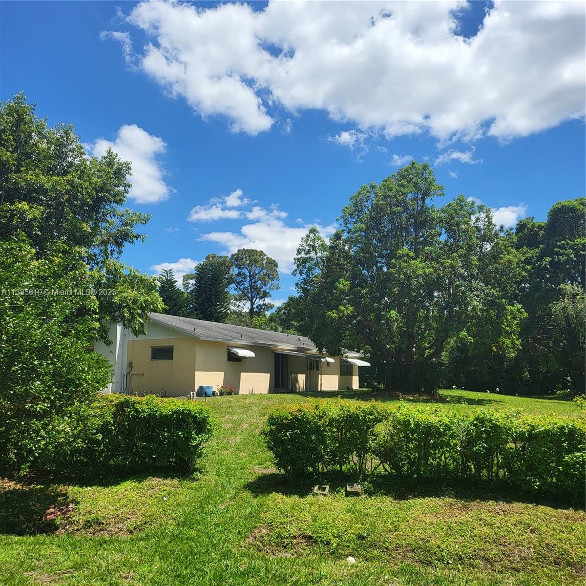 915 B Road Loxahatchee, FL 33470 - Photo 3 of 42 a front view of a house with a yard