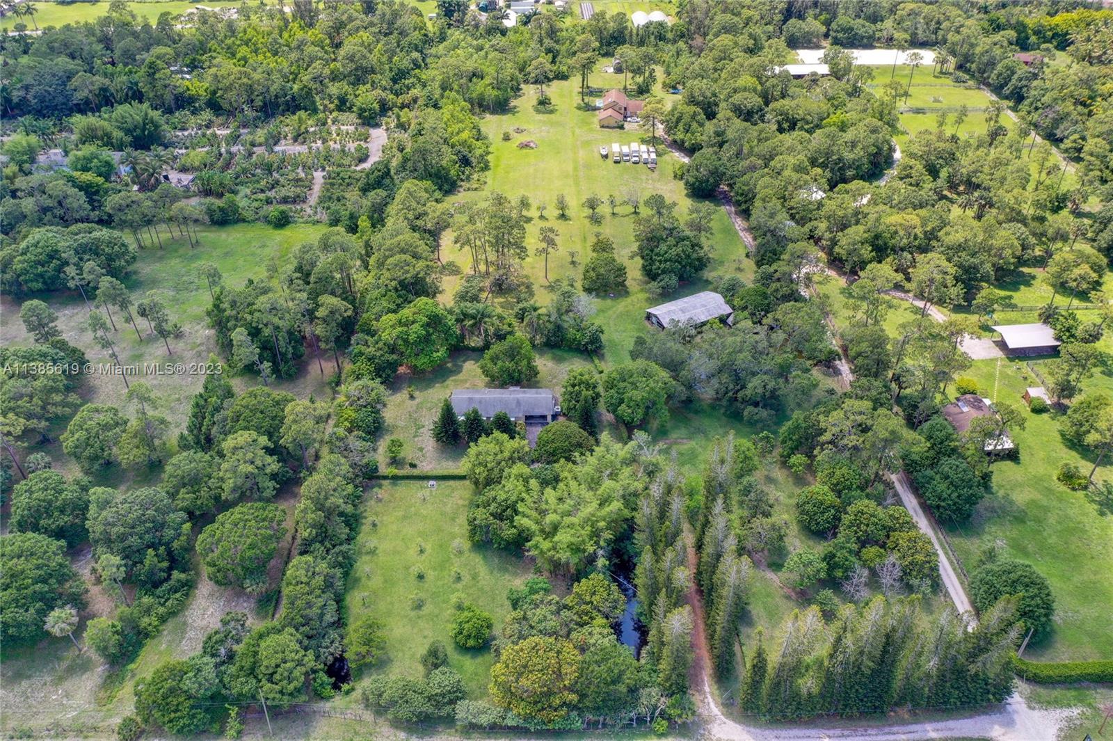 915 B Road Loxahatchee, FL 33470 - Photo 33 of 42 an aerial view of residential house with outdoor space and trees all around