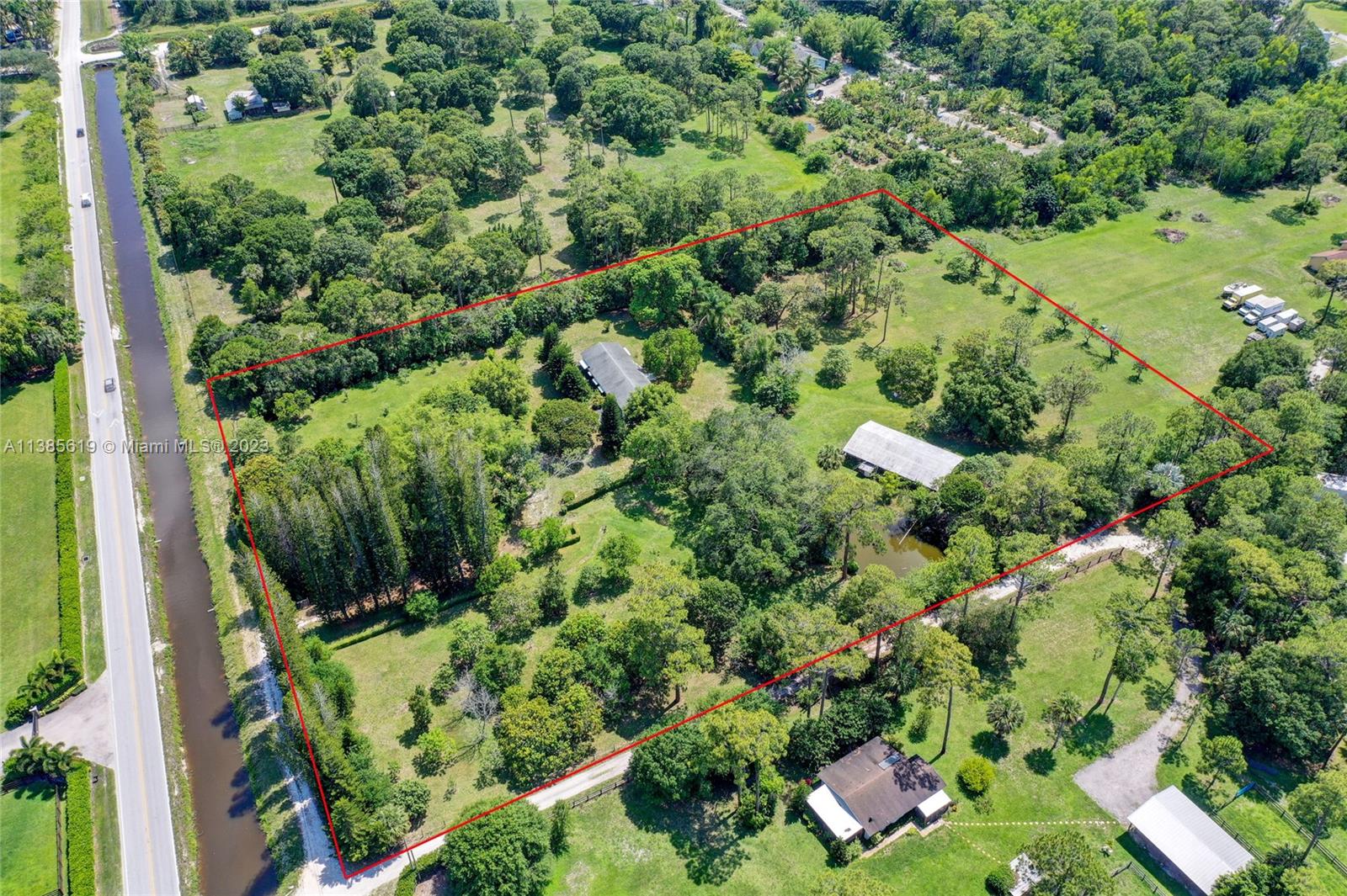 915 B Road Loxahatchee, FL 33470 - Photo 34 of 42 an aerial view of residential house with outdoor space and trees all around