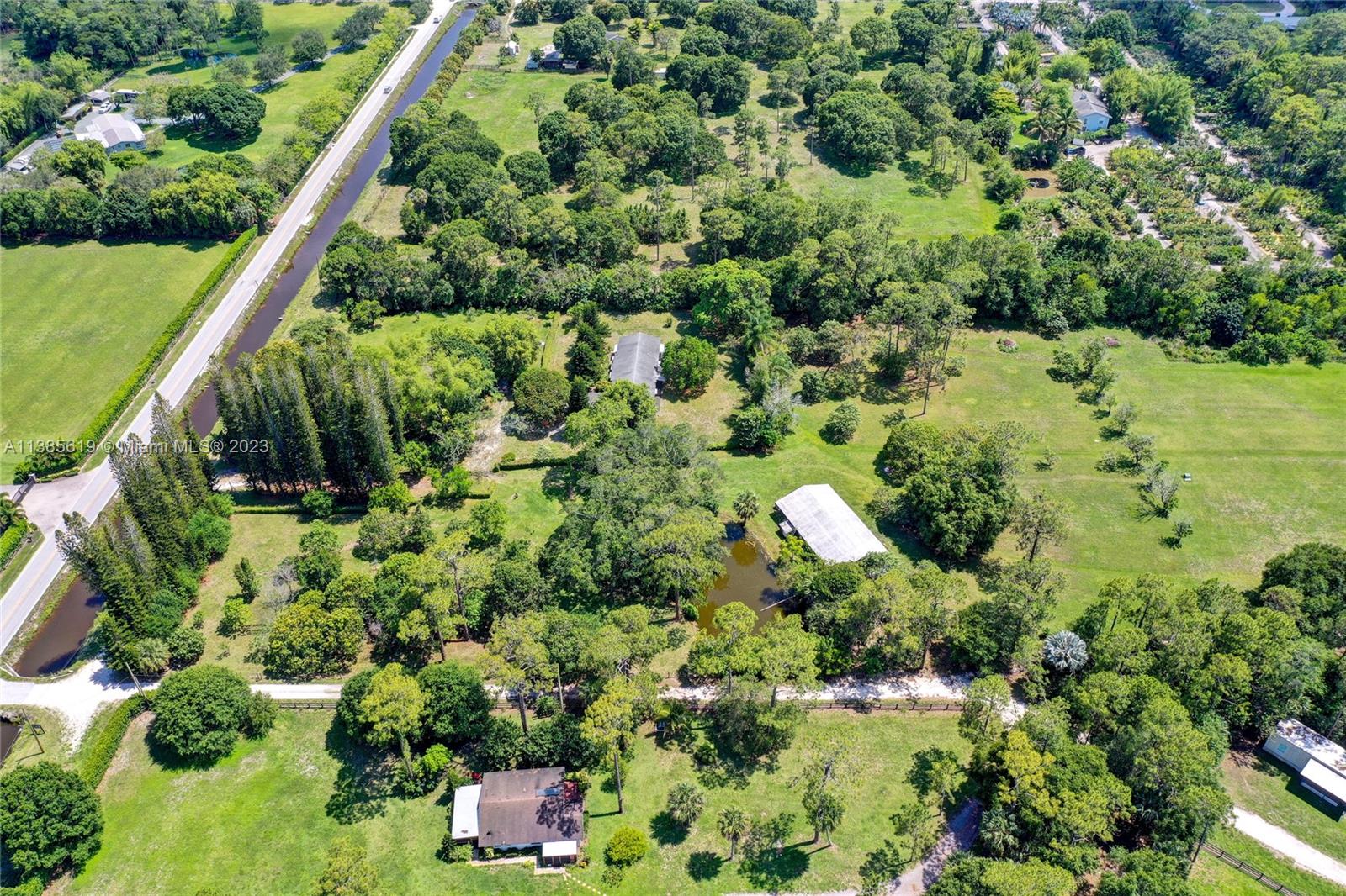 915 B Road Loxahatchee, FL 33470 - Photo 35 of 42 an aerial view of residential house with outdoor space and trees all around