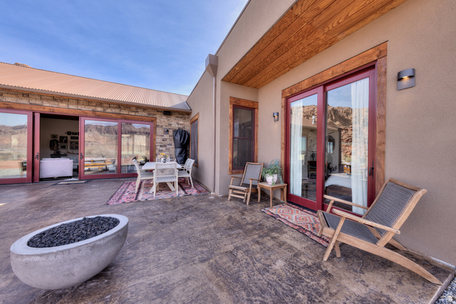 4173 Shadowfax Run, Unit 5 Moab, UT 84532 - Photo 35 of 41 Patio featuring outdoor dining area, stained stamped concrete, and built in outdoor fire pit