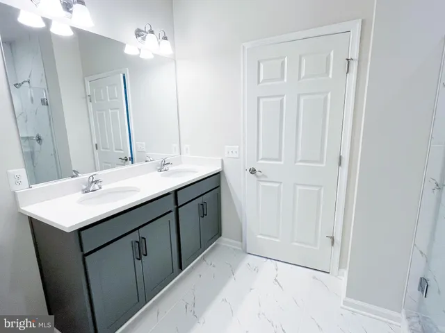 a bathroom with a double vanity sink a and a mirror