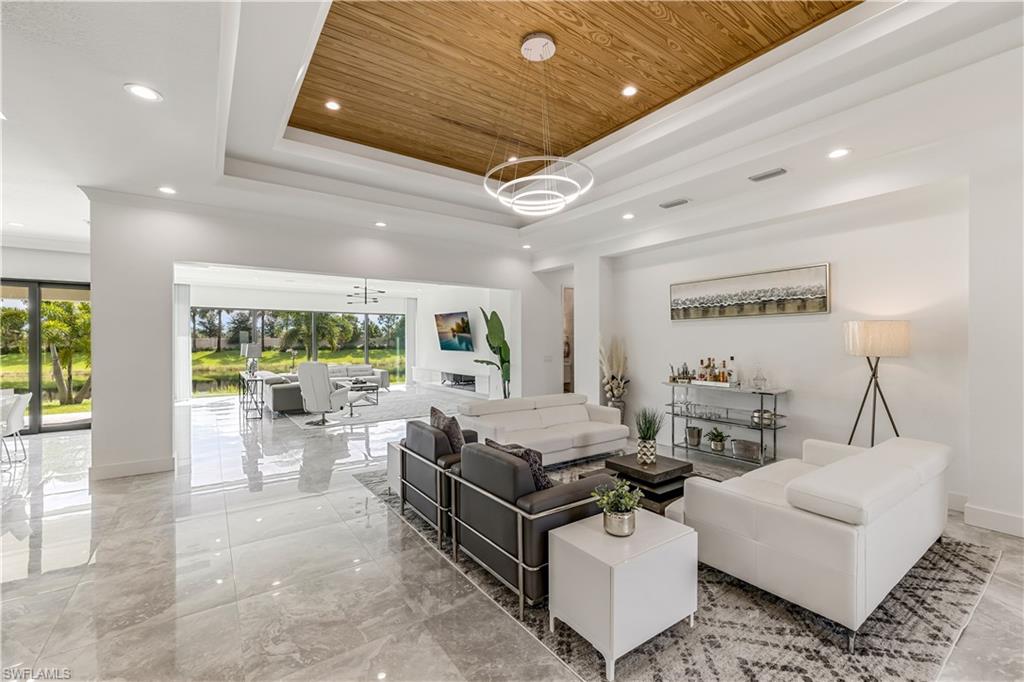 4410 Caldera Circle Naples, FL 34119 - Photo 12 of 30 a living room with furniture and a large window