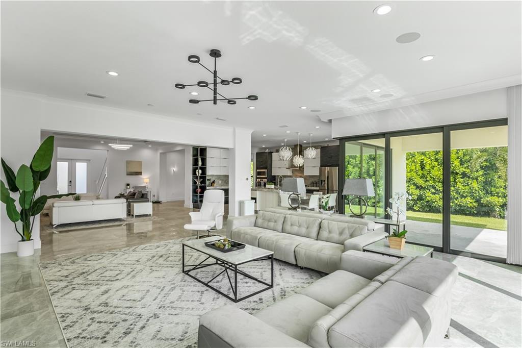 4410 Caldera Circle Naples, FL 34119 - Photo 18 of 30 a living room with furniture and a large window