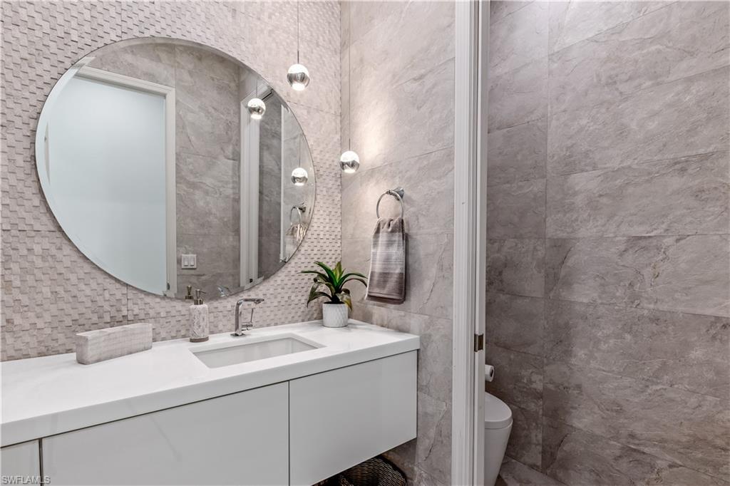 4410 Caldera Circle Naples, FL 34119 - Photo 20 of 30 a bathroom with a sink and a mirror