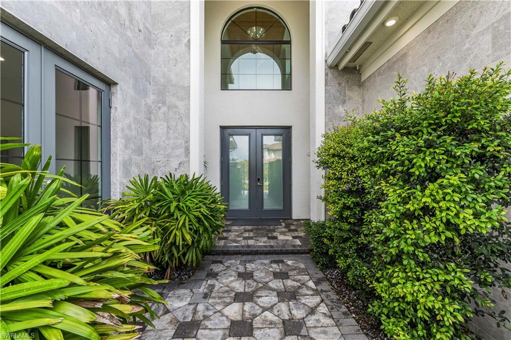 4410 Caldera Circle Naples, FL 34119 - Photo 2 of 30 a front view of a house with garden
