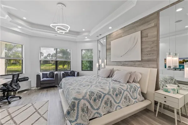 a spacious bedroom with a bed a couch and dresser