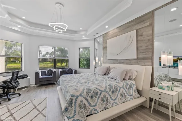 a spacious bedroom with a bed a couch and dresser