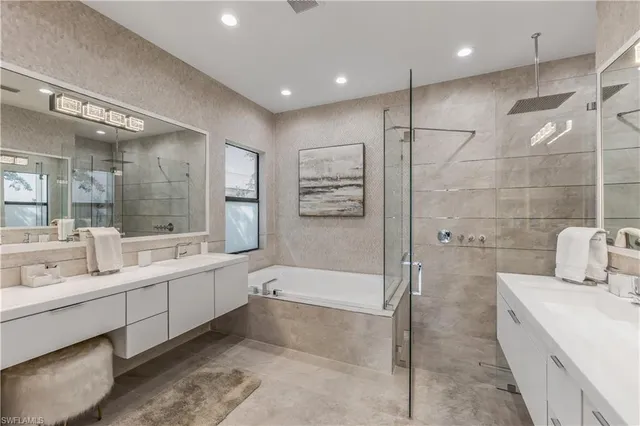a large bathroom with a double vanity sink a large mirror and shower