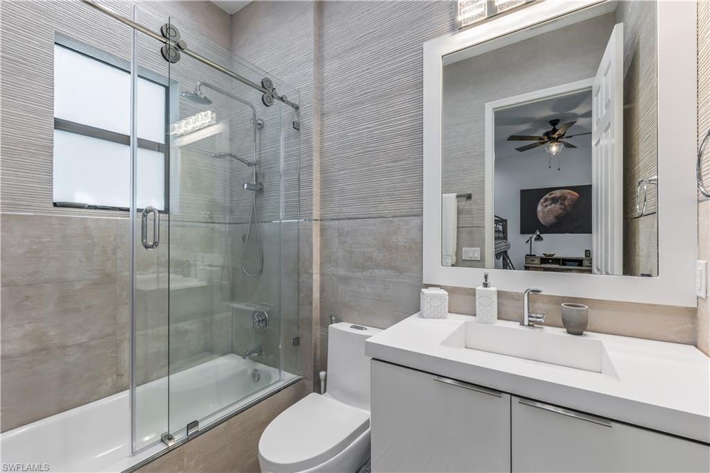 4410 Caldera Circle Naples, FL 34119 - Photo 25 of 30 a bathroom with a sink toilet and shower