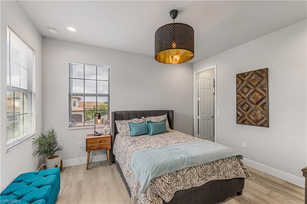 4410 Caldera Circle Naples, FL 34119 - Photo 27 of 30 a bedroom with a bed and a potted plant