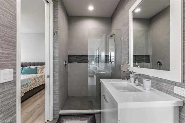 a bathroom with a sink a mirror and shower