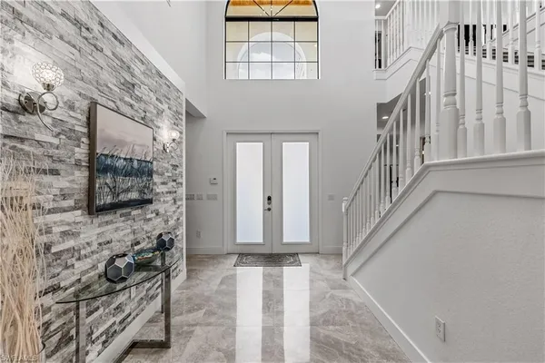 a view of entryway with a front door and wooden floor