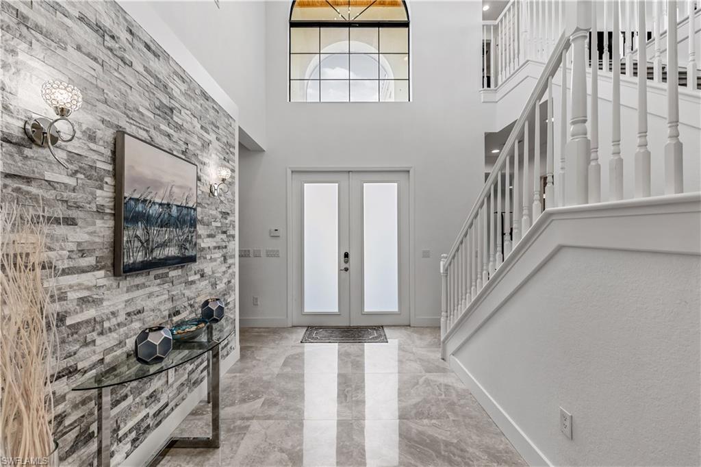 4410 Caldera Circle Naples, FL 34119 - Photo 4 of 30 a view of entryway with a front door and wooden floor