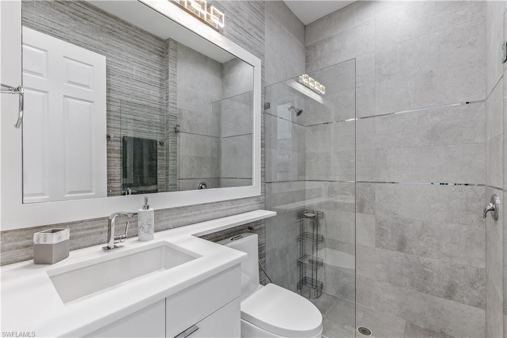 4410 Caldera Circle Naples, FL 34119 - Photo 7 of 30 a bathroom with a sink toilet vanity and shower