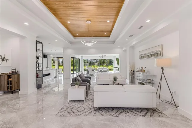 a living room with furniture and a floor to ceiling window