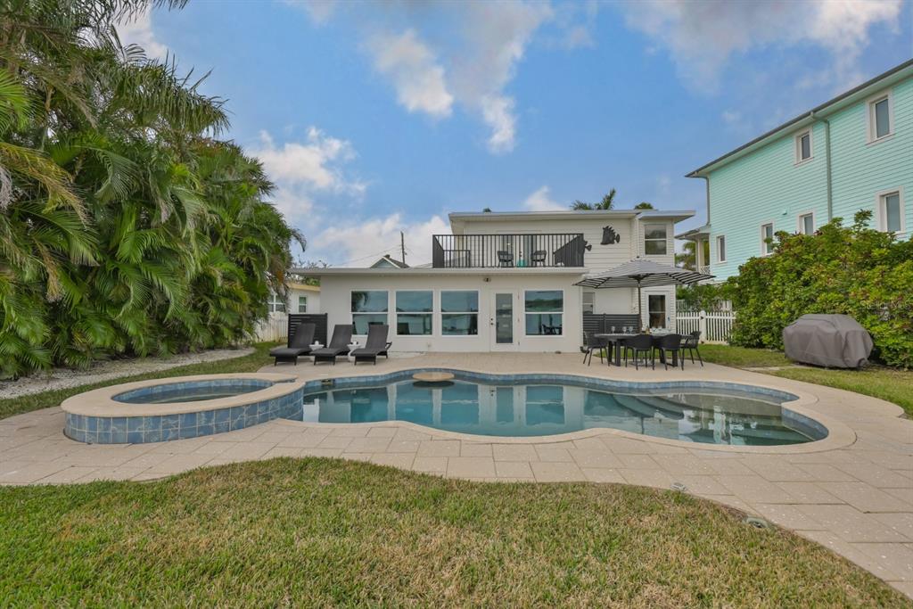 387 12th Avenue Indian Rocks Beach, FL 33785 - Photo 12 of 44 a view of a house with a swimming pool