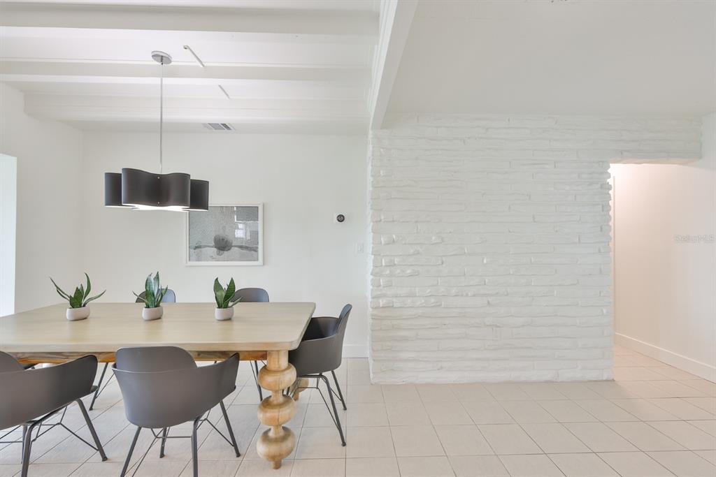 387 12th Avenue Indian Rocks Beach, FL 33785 - Photo 20 of 44 a view of a dining room with furniture and wooden floor